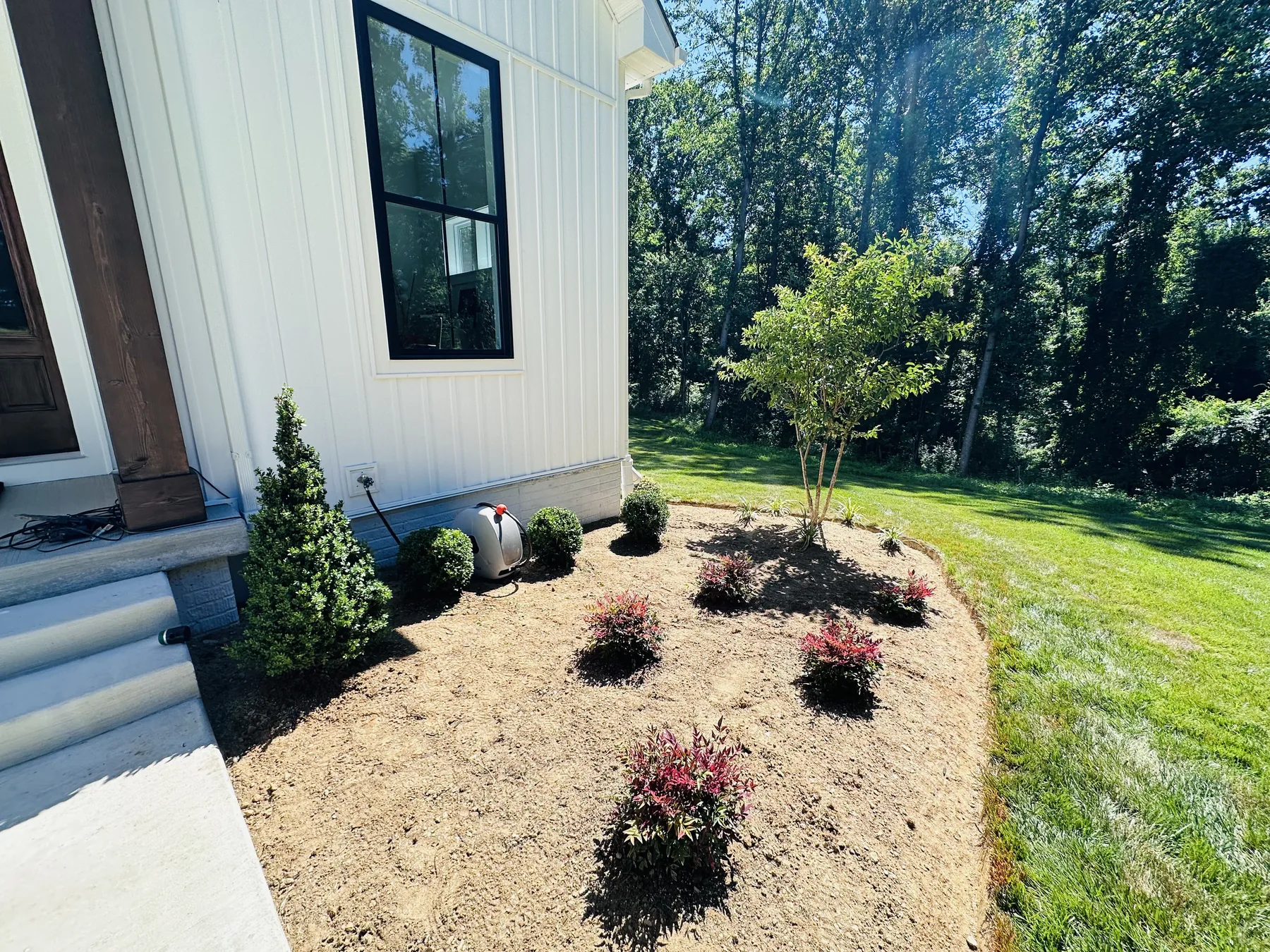 Clean landscape bed edges and newly planted shrubs next to a lawn in Harford County, MD