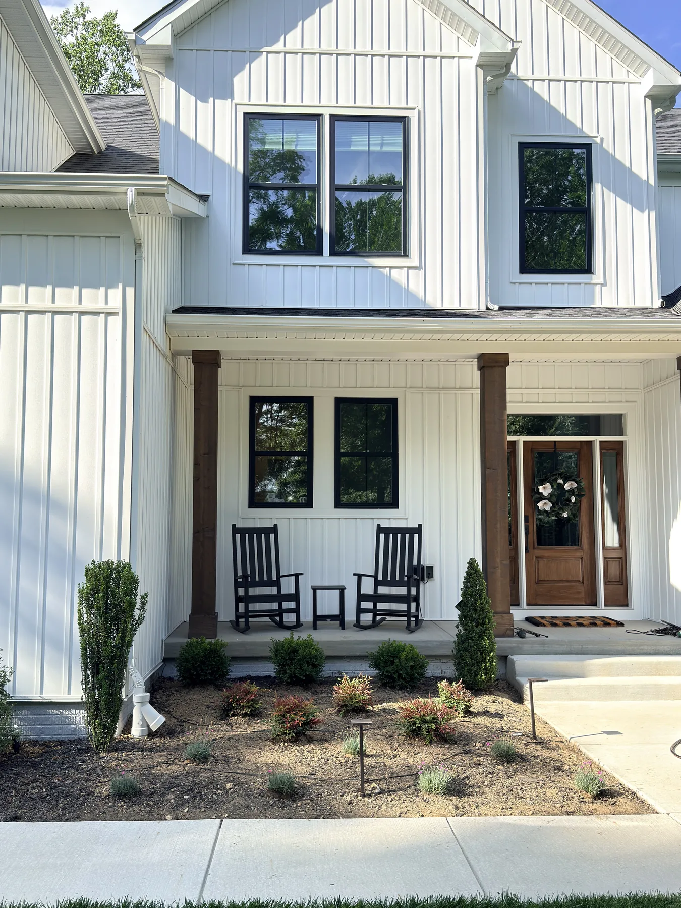 New foundation shrubs and plantings at a farmhouse front porch in Harford County, MD